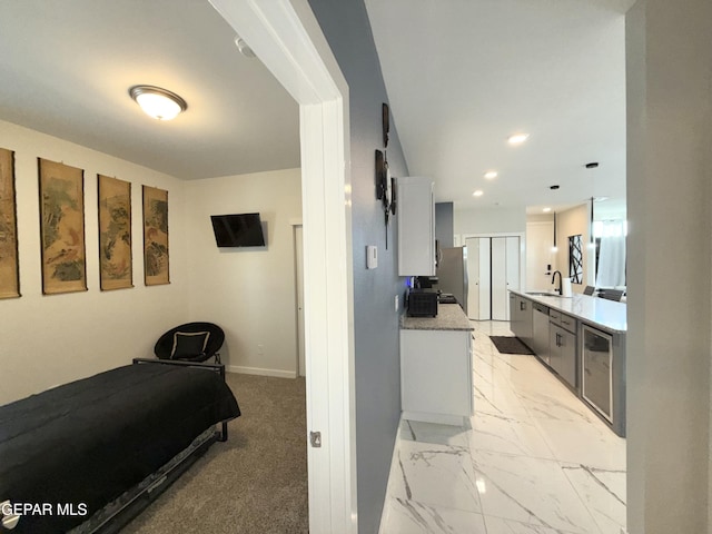 bedroom featuring sink and stainless steel refrigerator