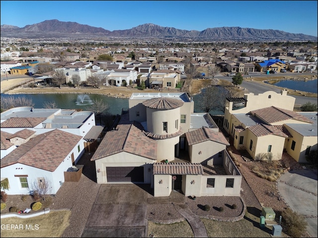 bird's eye view with a water and mountain view