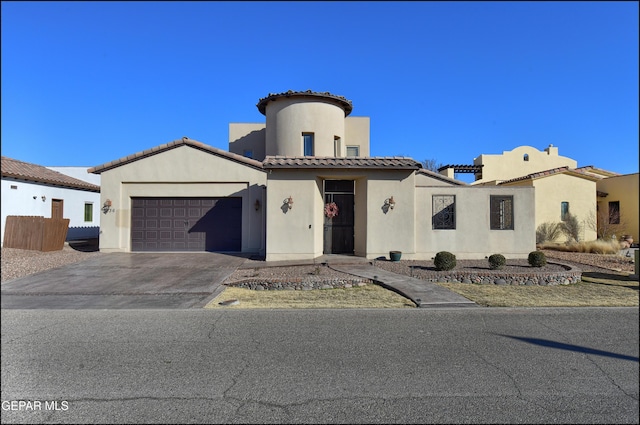 mediterranean / spanish home featuring a garage