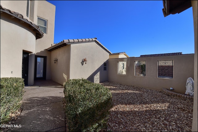 view of side of home featuring a patio