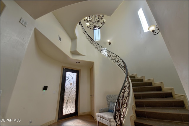 entrance foyer with a notable chandelier and a high ceiling