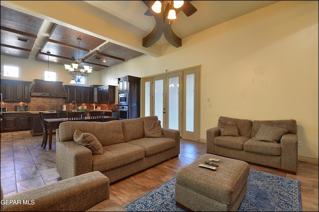 living room with beamed ceiling, a healthy amount of sunlight, and coffered ceiling