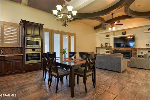 dining area featuring ceiling fan with notable chandelier and french doors