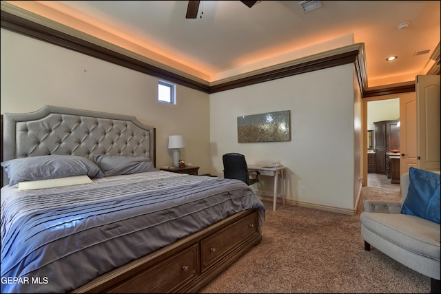 bedroom featuring carpet, ceiling fan, and a tray ceiling