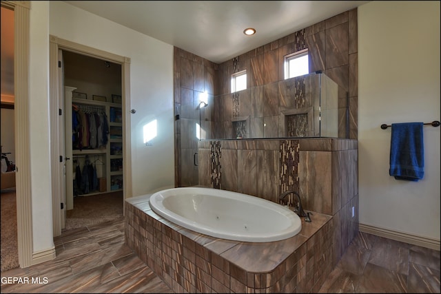 bathroom featuring independent shower and bath