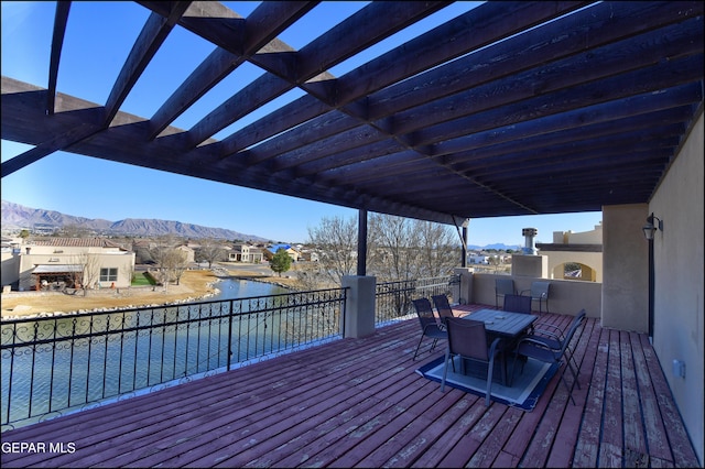 deck featuring a pergola and a water and mountain view