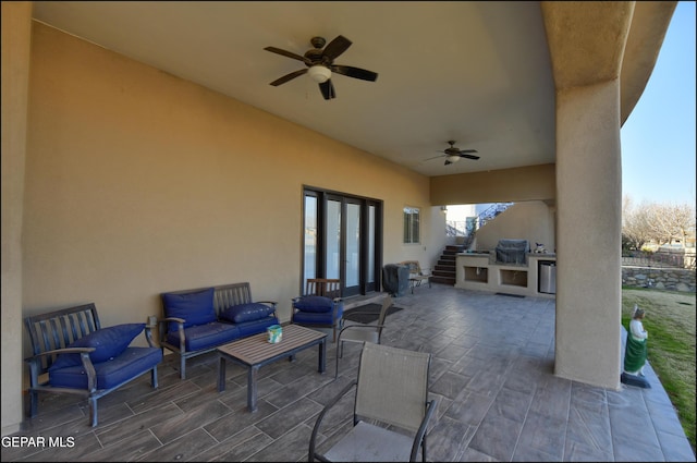 view of patio / terrace with an outdoor living space, ceiling fan, and an outdoor kitchen