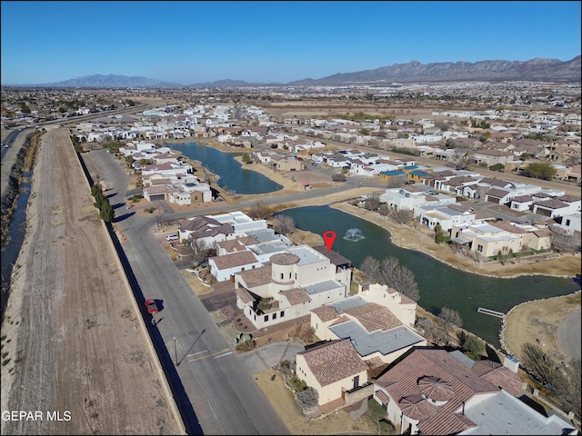 drone / aerial view with a water and mountain view