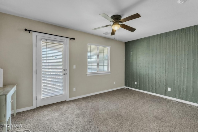 unfurnished room with carpet flooring and ceiling fan