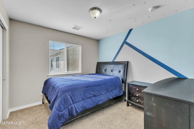 bedroom with light colored carpet and a closet