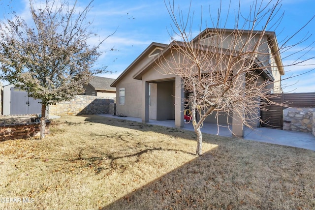 rear view of house with a yard and a patio