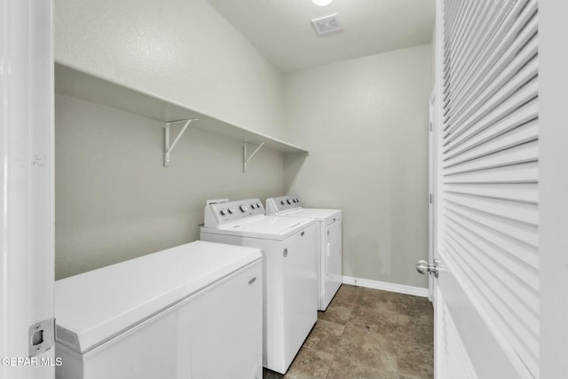 clothes washing area featuring separate washer and dryer