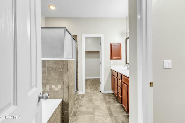 bathroom featuring vanity and shower with separate bathtub