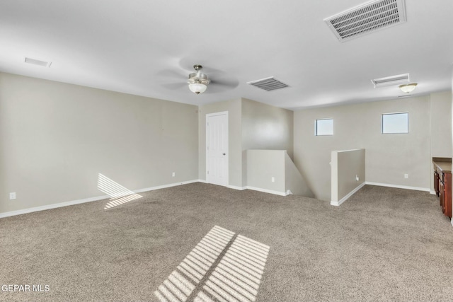 empty room with ceiling fan and carpet flooring