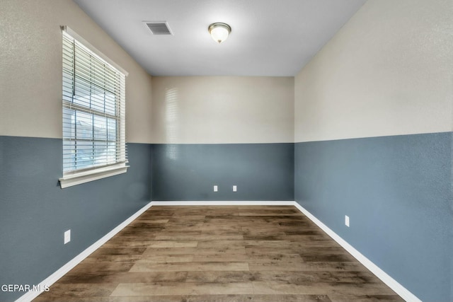 unfurnished room with hardwood / wood-style floors