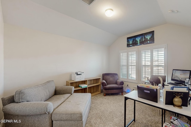 carpeted home office with vaulted ceiling