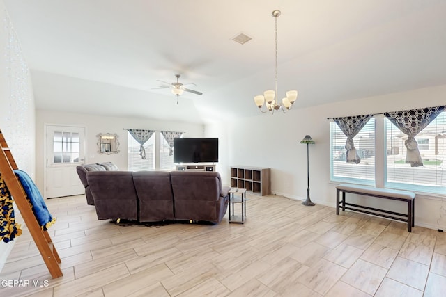 living room featuring lofted ceiling and ceiling fan with notable chandelier