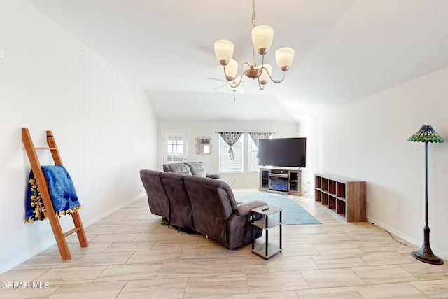 living room featuring lofted ceiling and a chandelier