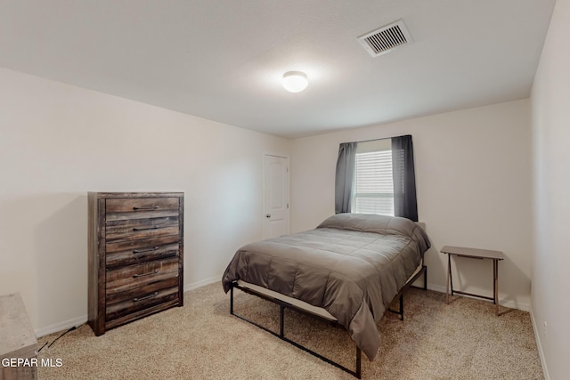 bedroom with light colored carpet