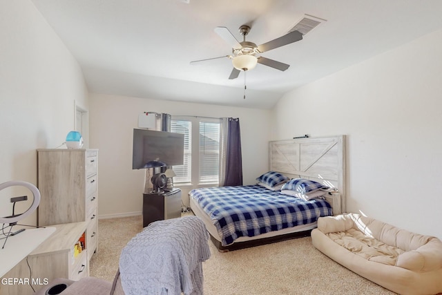 carpeted bedroom featuring ceiling fan and vaulted ceiling