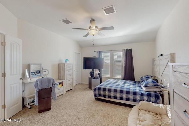 carpeted bedroom with ceiling fan and vaulted ceiling