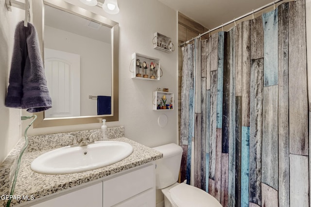 bathroom with vanity, toilet, and a shower with shower curtain