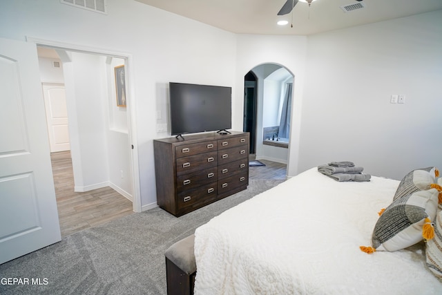 bedroom featuring ceiling fan, ensuite bathroom, and carpet