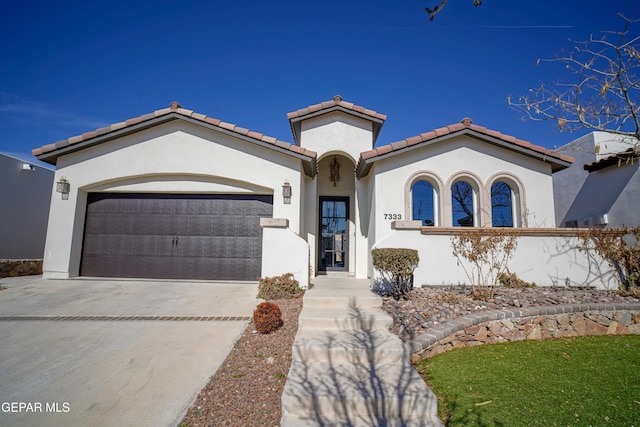 mediterranean / spanish house featuring a garage