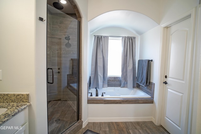 bathroom with vanity, wood-type flooring, and shower with separate bathtub