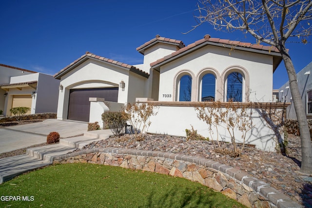 mediterranean / spanish house with a garage