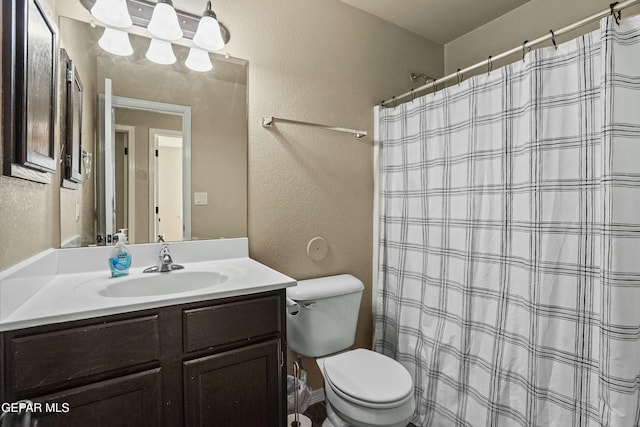 bathroom with vanity, toilet, and curtained shower