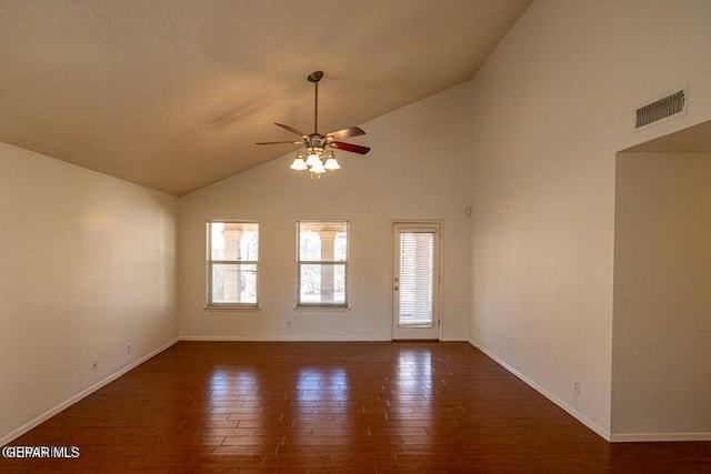 empty room featuring ceiling fan, dark hardwood / wood-style flooring, and vaulted ceiling