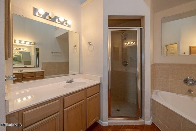 bathroom featuring vanity and separate shower and tub