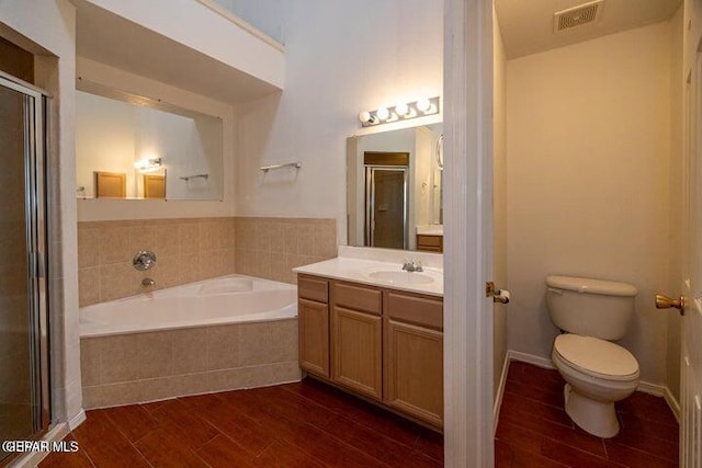 full bathroom featuring vanity, toilet, and plus walk in shower