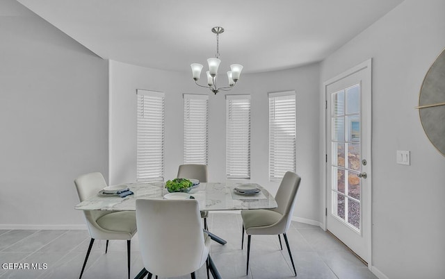 tiled dining area with an inviting chandelier