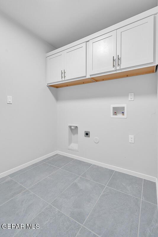 laundry area featuring tile patterned floors, cabinets, hookup for a washing machine, electric dryer hookup, and hookup for a gas dryer