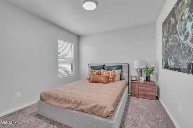 bedroom featuring light colored carpet