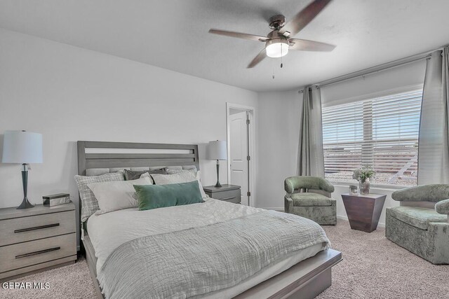 bedroom with light carpet and ceiling fan