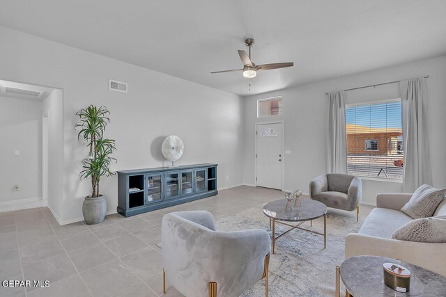 tiled living room featuring ceiling fan