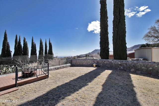 view of yard featuring a patio and a mountain view