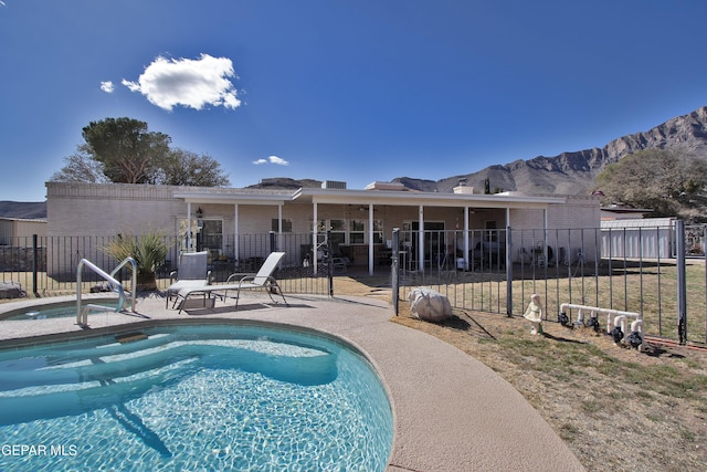 view of pool featuring a mountain view and a patio area