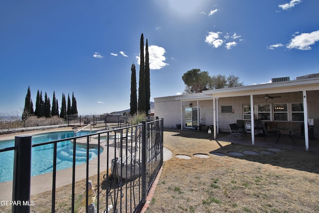 view of swimming pool featuring a patio and ceiling fan