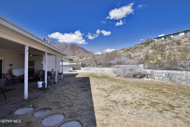 view of yard with a mountain view and a patio