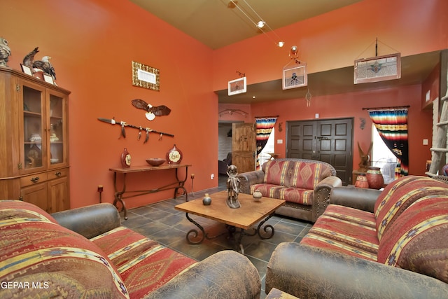 tiled living room featuring a high ceiling