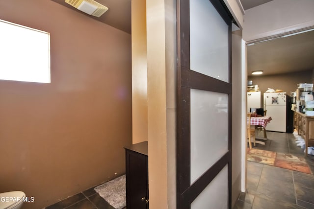 corridor with dark tile patterned floors