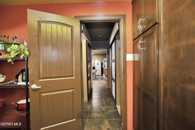 corridor with dark tile patterned flooring