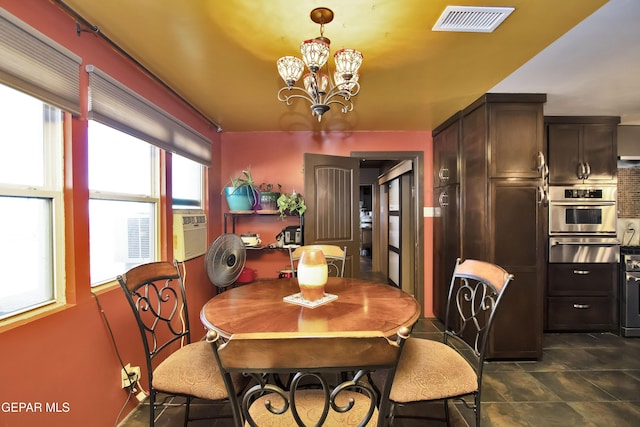 dining area featuring a notable chandelier