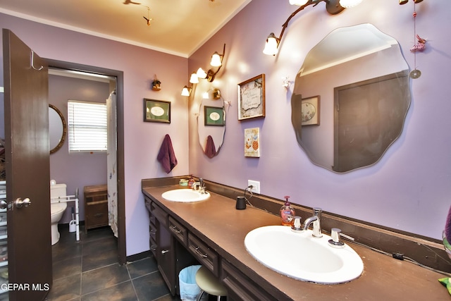 bathroom featuring vanity, tile patterned floors, and toilet