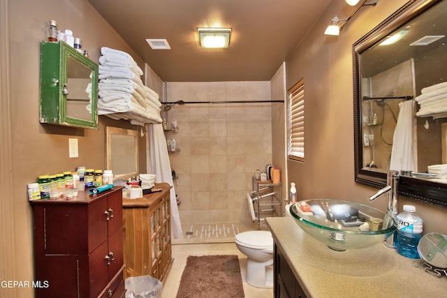 bathroom with toilet, vanity, tile patterned floors, and a shower with shower curtain