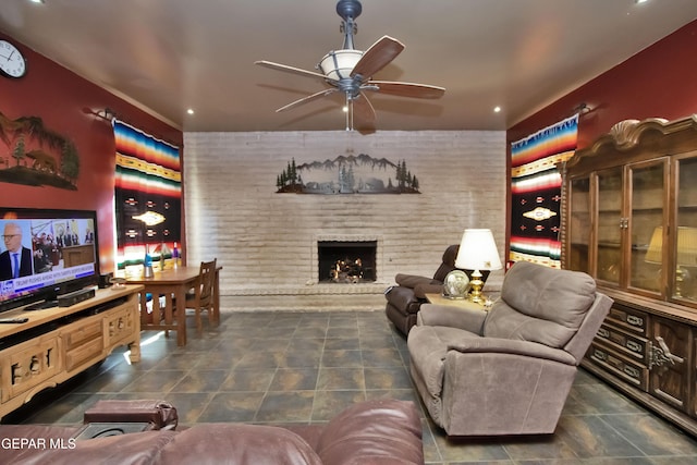 living room featuring ceiling fan, brick wall, and a fireplace